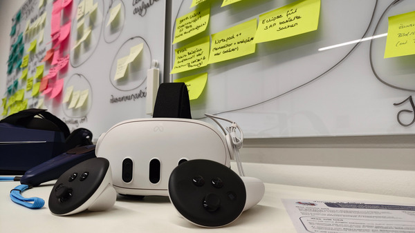 VR glasses lying infront of a whiteboard with writing on it